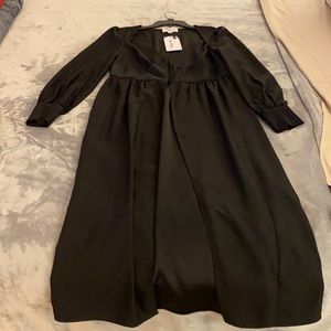 Black full length dress with buttons.